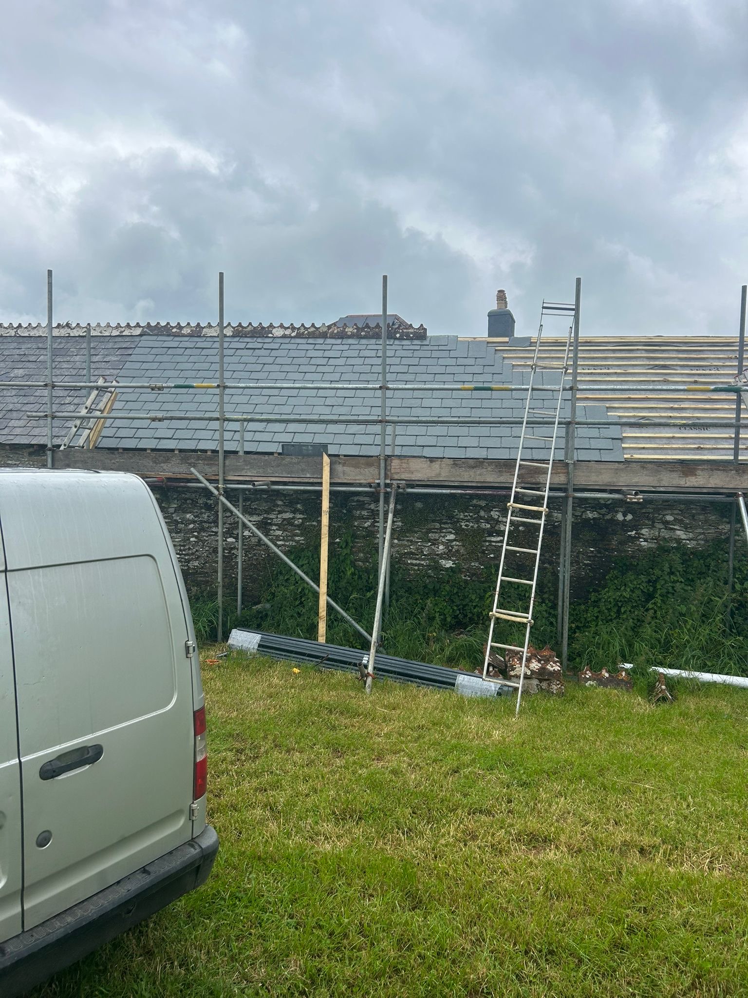 NAC Roofing roof project with scaffolding and solar panels